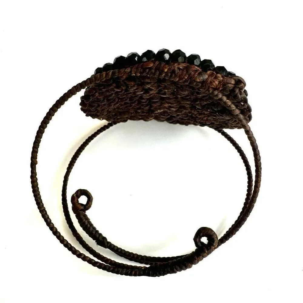 Round  black beaded bracelet on brown cord